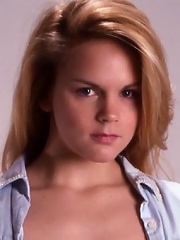 Fiery blonde slowly gets undressed in her apartment.